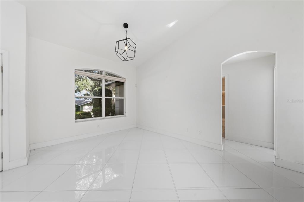 11036 Bronson Road Clermont, FL 34711 - Photo 8 of 29 an empty room with windows and ceiling fan