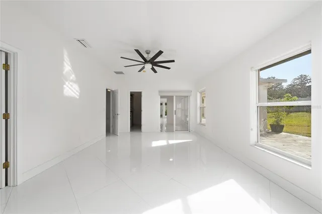 a view of a livingroom with a ceiling fan and window