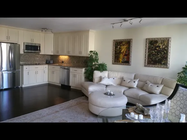 a living room with furniture and kitchen view