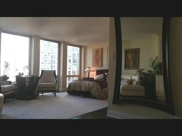a living room with furniture and large windows