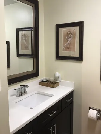 a bathroom with a sink mirror and vanity