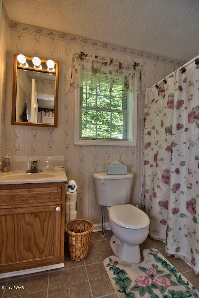 145 Keystone Road Lake Ariel, PA 18436 - Photo 33 of 52 a bathroom with a toilet sink and mirror