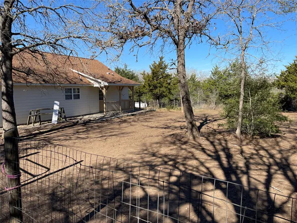 a view of a backyard with large trees