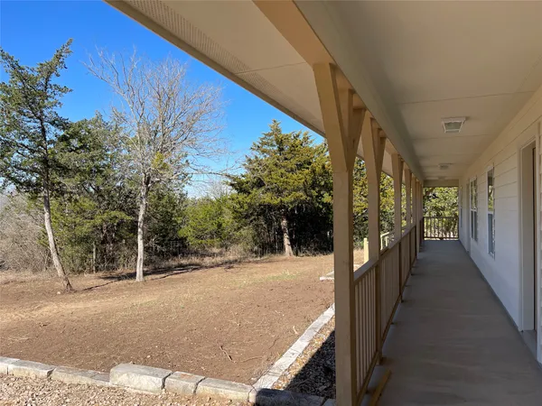a view of a pathway with a wrought fence