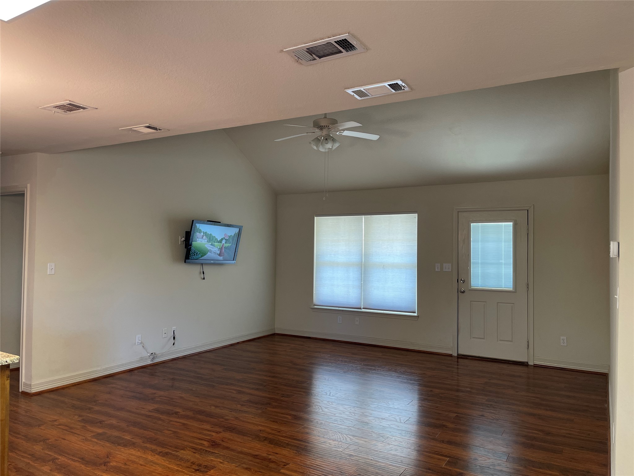 6164 South Fm 535 Road Cedar Creek, TX 78612 - Photo 14 of 27 an empty room with wooden floor and windows