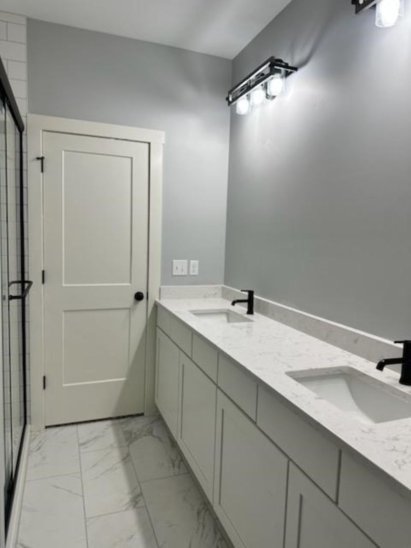 634 Anjali Court, Unit R Sycamore, IL 60178 - Photo 12 of 20 a bathroom with a sink and mirror