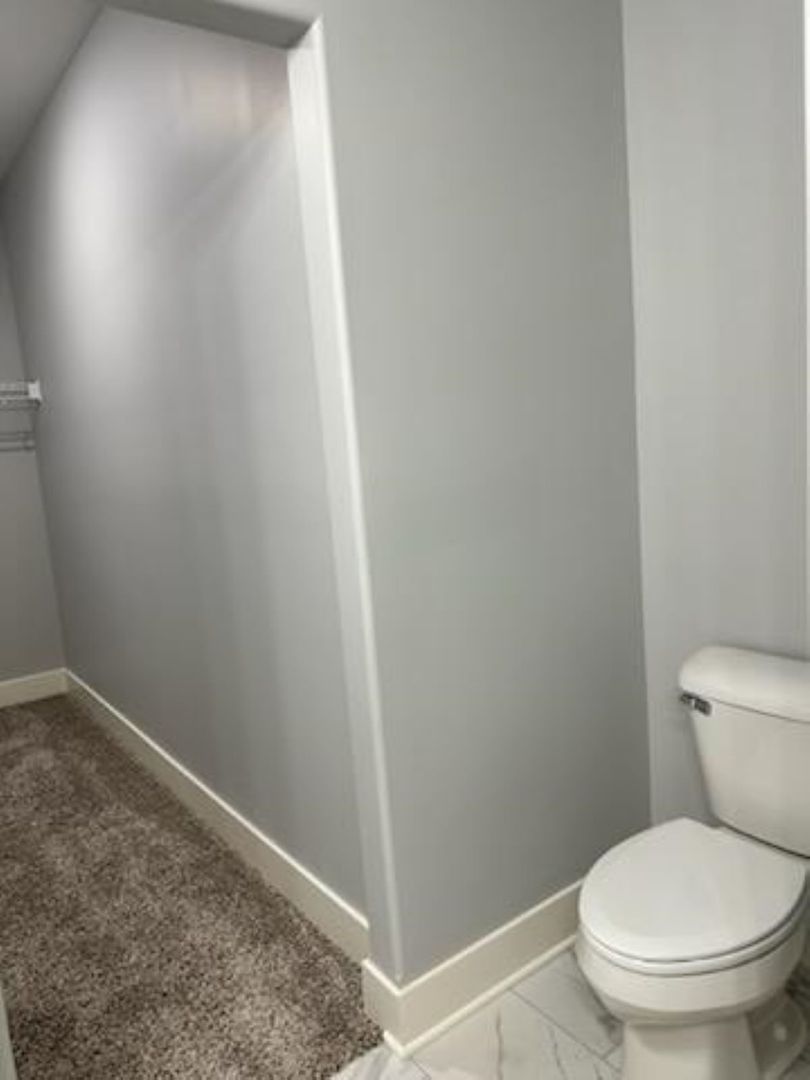 634 Anjali Court, Unit R Sycamore, IL 60178 - Photo 13 of 20 a white toilet sitting next to a shower