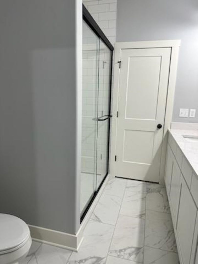 634 Anjali Court, Unit R Sycamore, IL 60178 - Photo 16 of 20 a bathroom with a granite countertop shower and a toilet