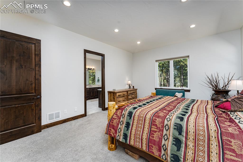 9775 Walker Road Colorado Springs, CO 80908 - Photo 12 of 50 a bedroom with a bed and a window