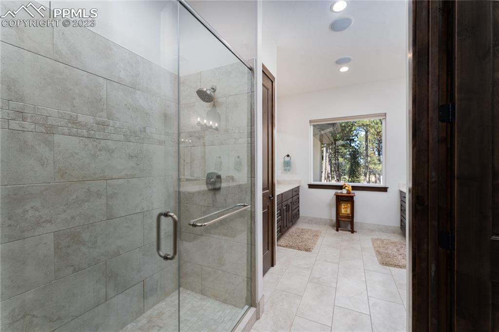 9775 Walker Road Colorado Springs, CO 80908 - Photo 16 of 50 a bathroom with a bathtub and a shower