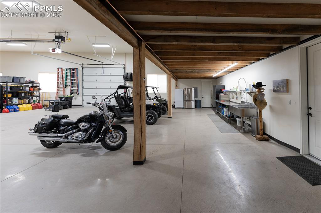 9775 Walker Road Colorado Springs, CO 80908 - Photo 20 of 50 a view of a garage with a bike and a roof