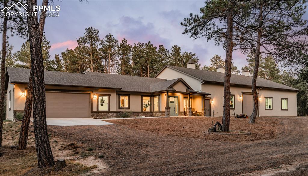 9775 Walker Road Colorado Springs, CO 80908 - Photo 2 of 50 a front view of a house with a yard