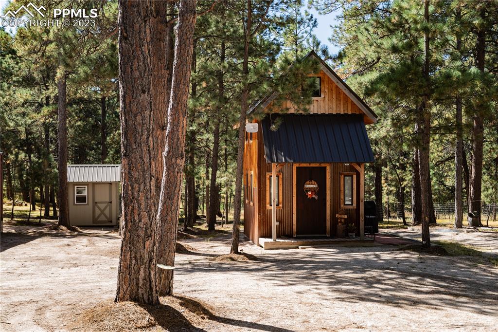 9775 Walker Road Colorado Springs, CO 80908 - Photo 33 of 50 a front view of a house with a tree