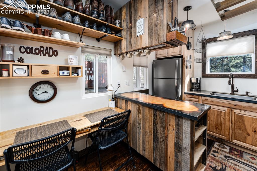 9775 Walker Road Colorado Springs, CO 80908 - Photo 34 of 50 a kitchen with a refrigerator and a stove