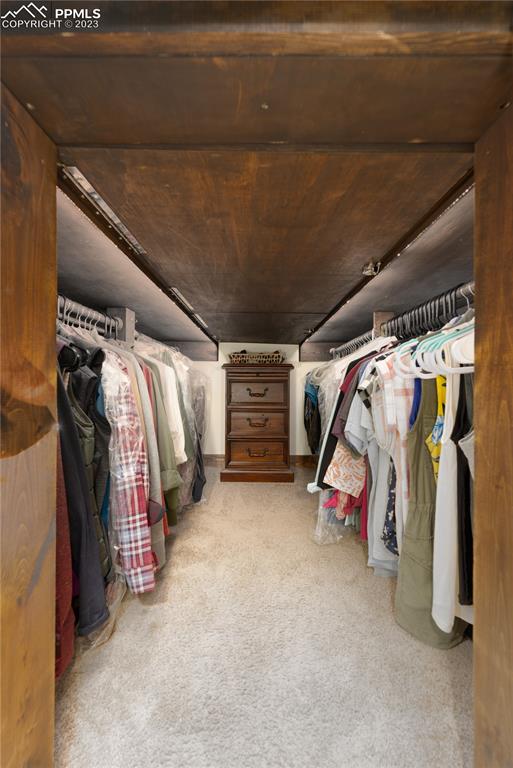 9775 Walker Road Colorado Springs, CO 80908 - Photo 38 of 50 a view of walk in closet with clothes and shoes