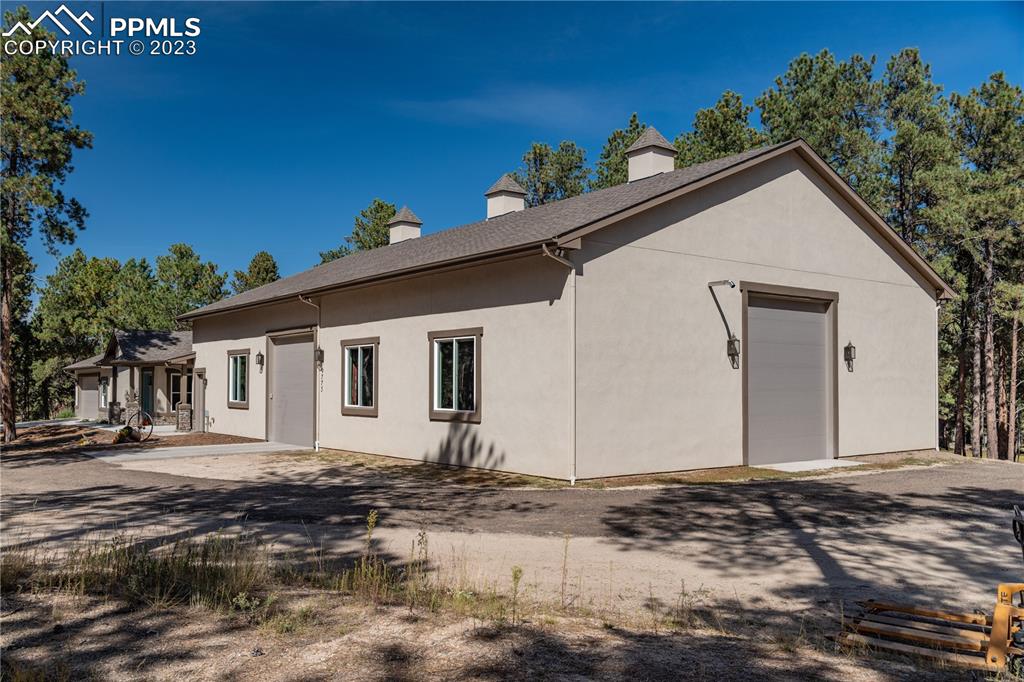 9775 Walker Road Colorado Springs, CO 80908 - Photo 41 of 50 a view of a house with a wooden deck