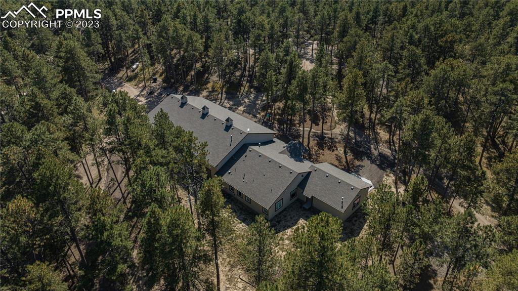 9775 Walker Road Colorado Springs, CO 80908 - Photo 42 of 50 an aerial view of a house with a yard and wooden fence
