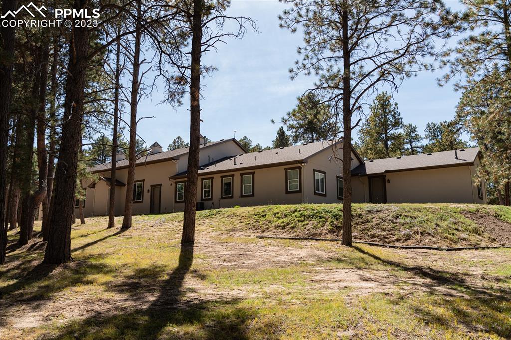 9775 Walker Road Colorado Springs, CO 80908 - Photo 43 of 50 a street view of a house with snow yard