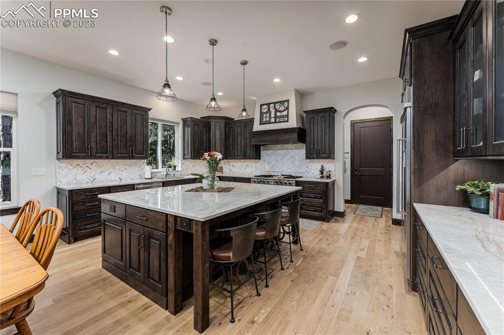 9775 Walker Road Colorado Springs, CO 80908 - Photo 8 of 50 a kitchen with kitchen island a large counter top space appliances and cabinets
