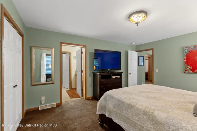 a bed room with a bed and a television