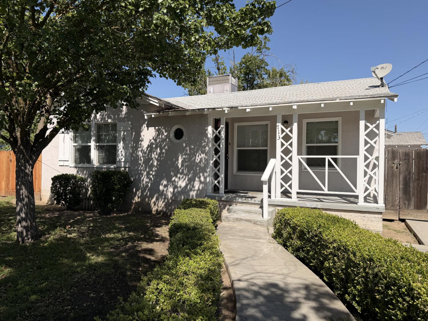 713 West 4th Street Madera, CA 93637 - Photo 1 of 28 a front view of a house with garden