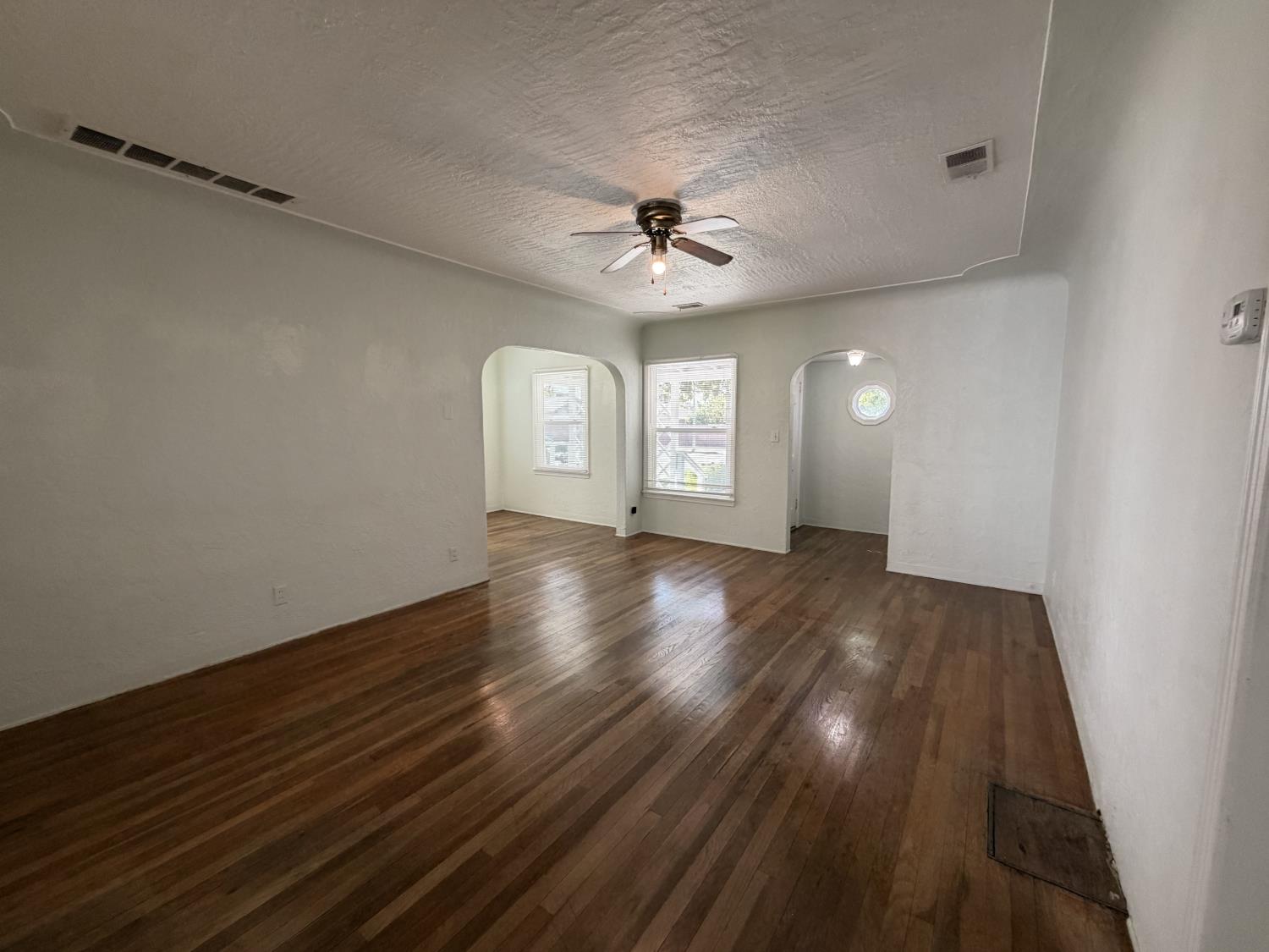 713 West 4th Street Madera, CA 93637 - Photo 11 of 28 wooden floor in an empty room with a window