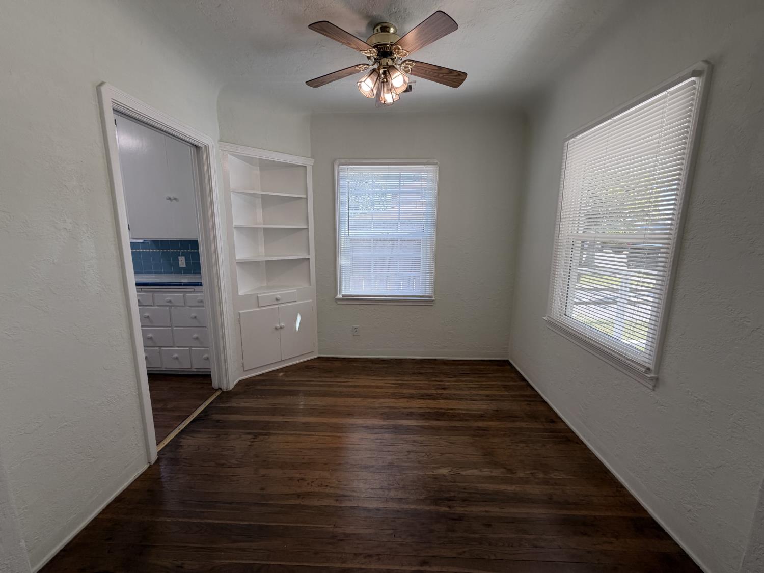 713 West 4th Street Madera, CA 93637 - Photo 12 of 28 a view of an empty room with a window and a kitchen