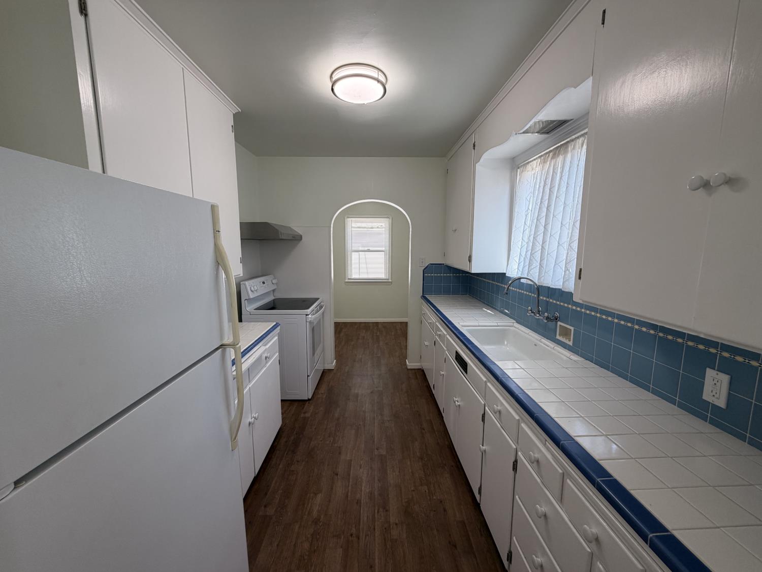 713 West 4th Street Madera, CA 93637 - Photo 13 of 28 a view of a kitchen with a sink and dishwasher