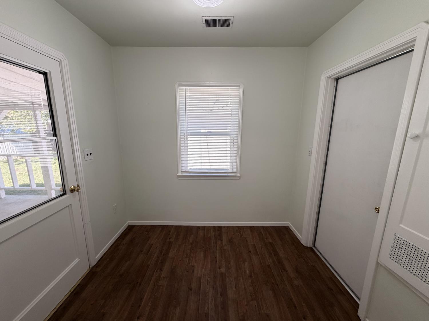 713 West 4th Street Madera, CA 93637 - Photo 14 of 28 an empty room with wooden floor and windows