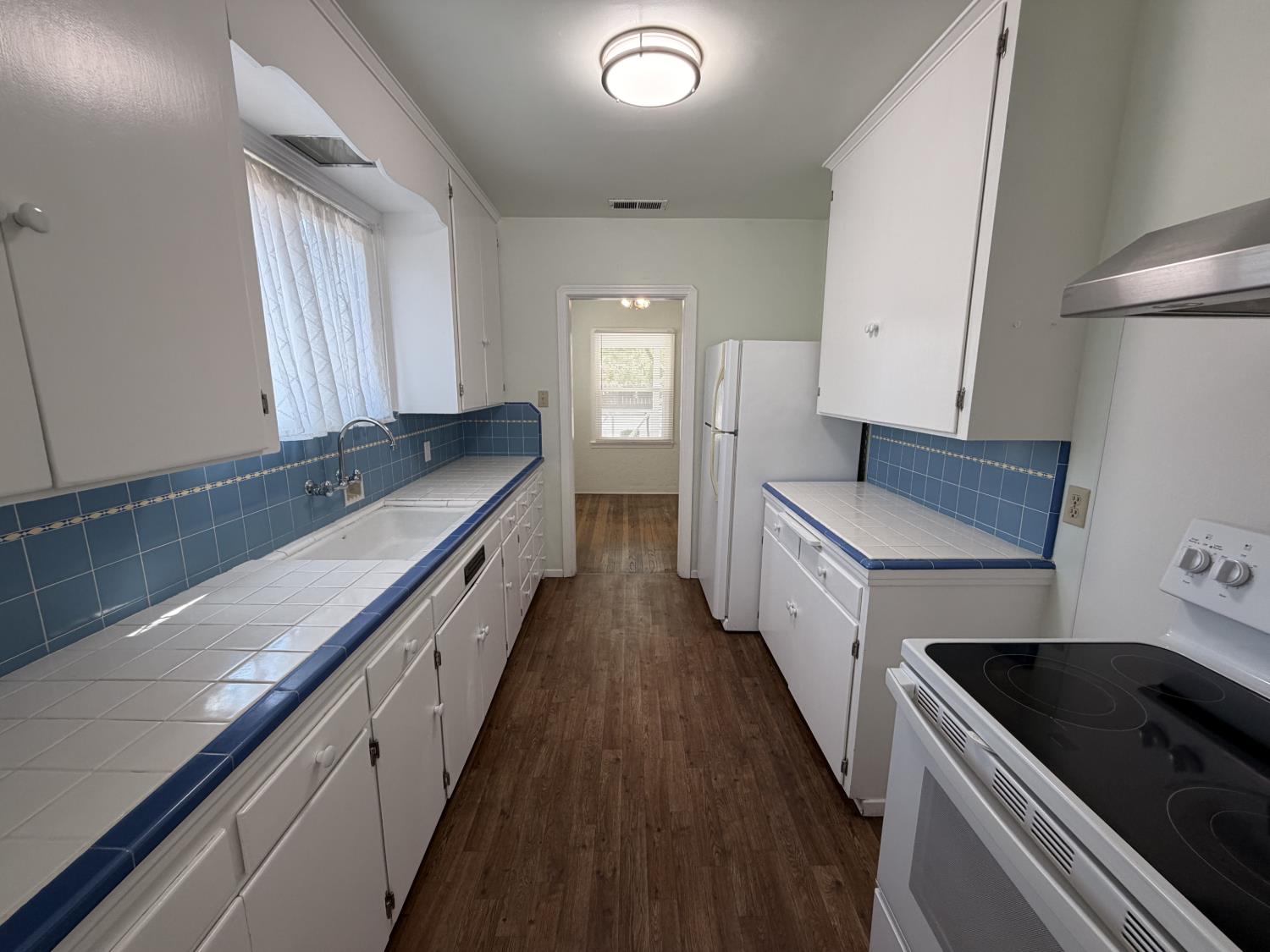 713 West 4th Street Madera, CA 93637 - Photo 15 of 28 a kitchen with granite countertop a sink and a stove top oven