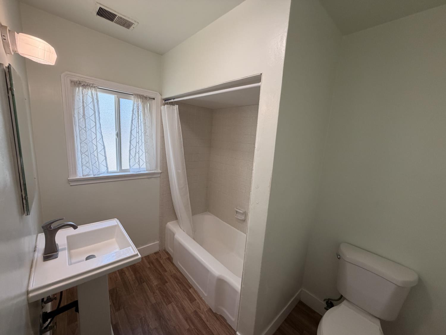 713 West 4th Street Madera, CA 93637 - Photo 18 of 28 a bathroom with a toilet sink and tub