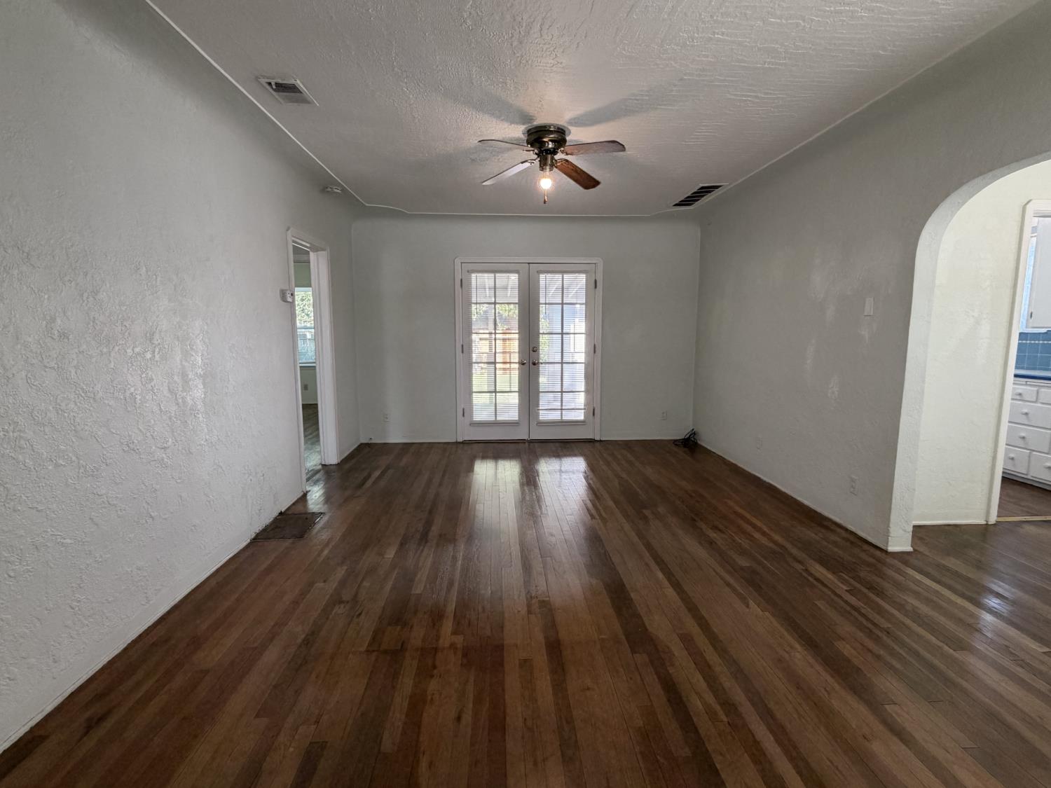 713 West 4th Street Madera, CA 93637 - Photo 9 of 28 wooden floor in an empty room with a window