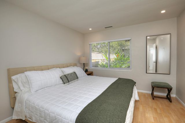 a bedroom with a bed and a chair