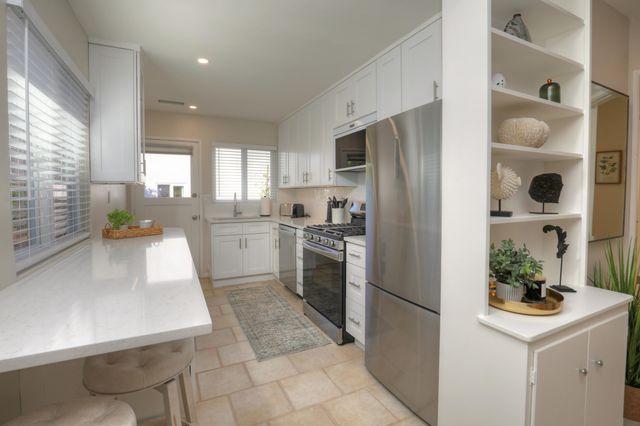 a kitchen with a refrigerator a sink and a stove