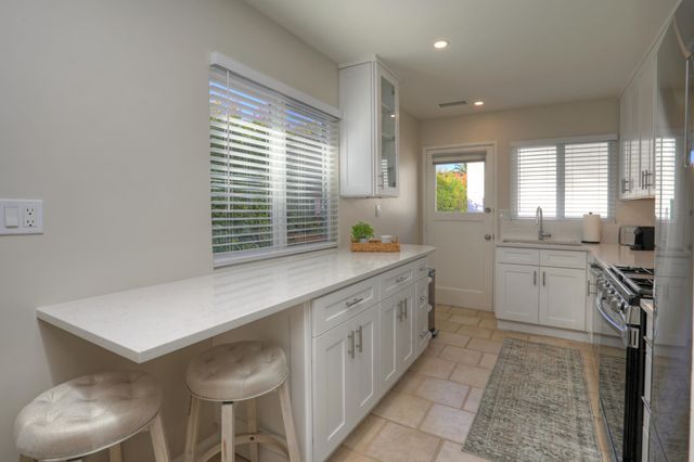 a kitchen with a sink stove and cabinets
