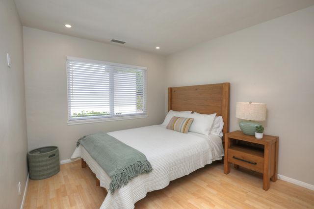 a bedroom with a bed and a chair