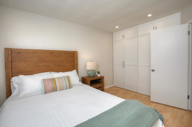 a bedroom with a bed and a night stand