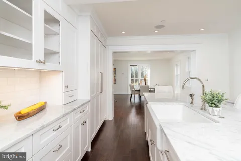 a spacious en suite bathroom with a granite countertop tub and a large mirror