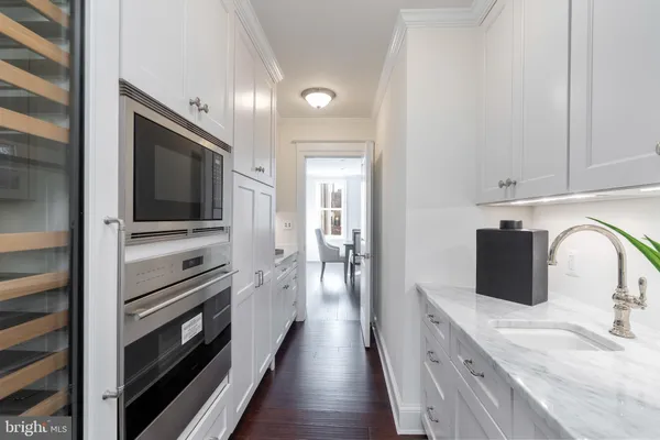 a kitchen with stainless steel appliances a stove microwave and sink
