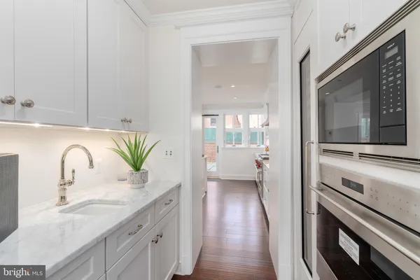 a en suite bathroom with a granite countertop sink and a mirror