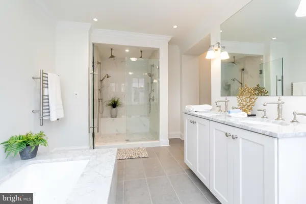 a bathroom with a granite countertop sink a mirror a shower and a bathtub
