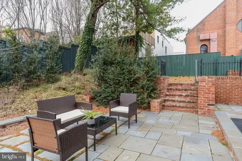a backyard of a house with outdoor seating