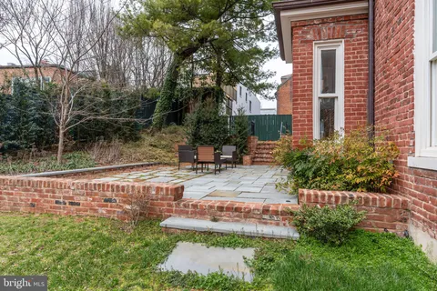 a view of backyard with swimming pool and outdoor seating