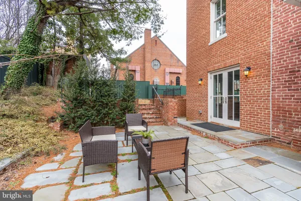 a front view of a house with outdoor seating