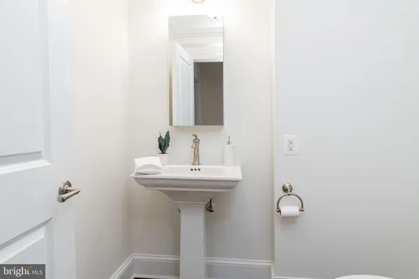 a bathroom with a sink a mirror and toilet