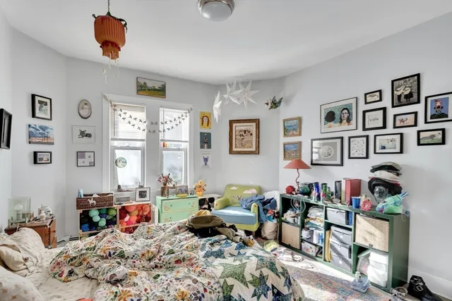 a bedroom with furniture a rug and a window