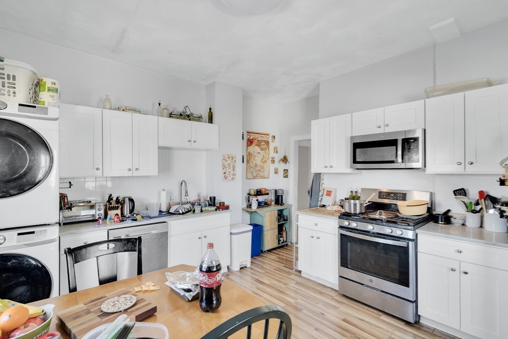 39 Union Street Boston, MA 02135 - Photo 15 of 27 a kitchen with a sink stove top oven and cabinets