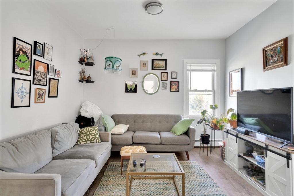 39 Union Street Boston, MA 02135 - Photo 18 of 27 a living room with furniture and a flat screen tv