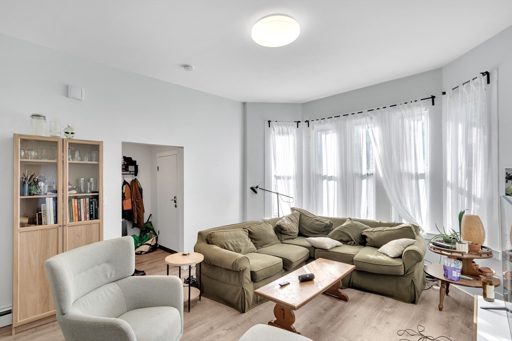 39 Union Street Boston, MA 02135 - Photo 2 of 27 a living room with furniture and a large window