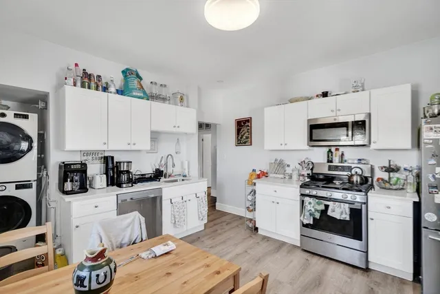 a kitchen with stainless steel appliances a stove sink and cabinets